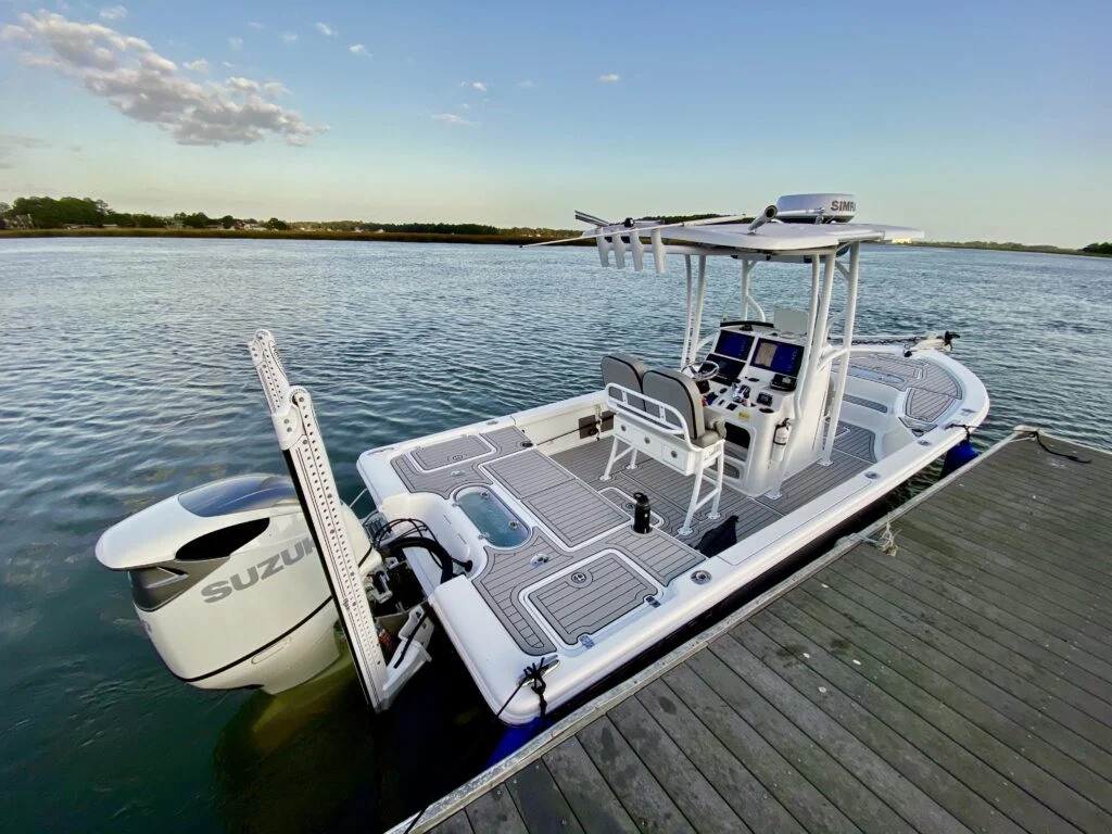 Sea Pro center console with a Suzuki outboard tied up at a floating dock